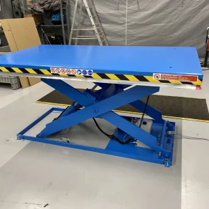 Blue scissor lift table in warehouse