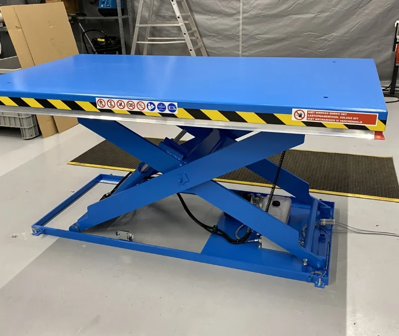 Blue scissor lift table in warehouse