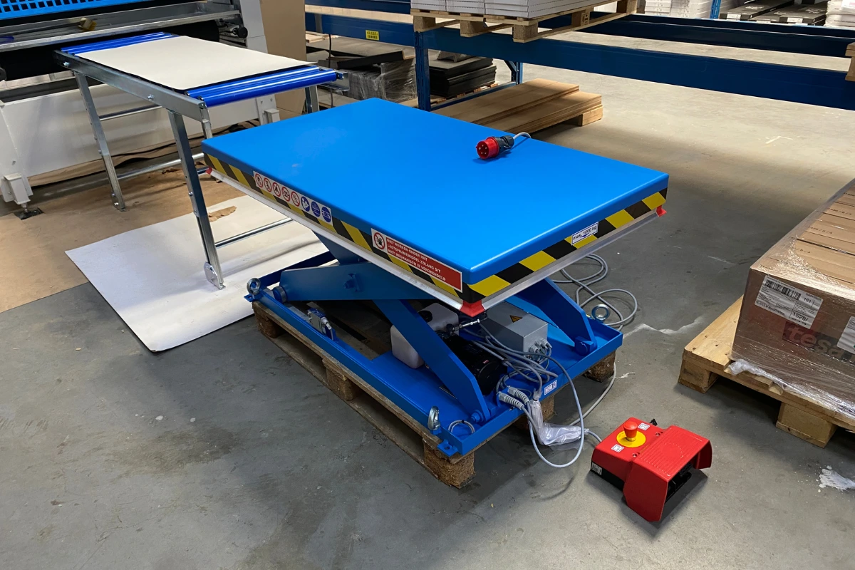 Top view of blue scissor lift table in warehouse.