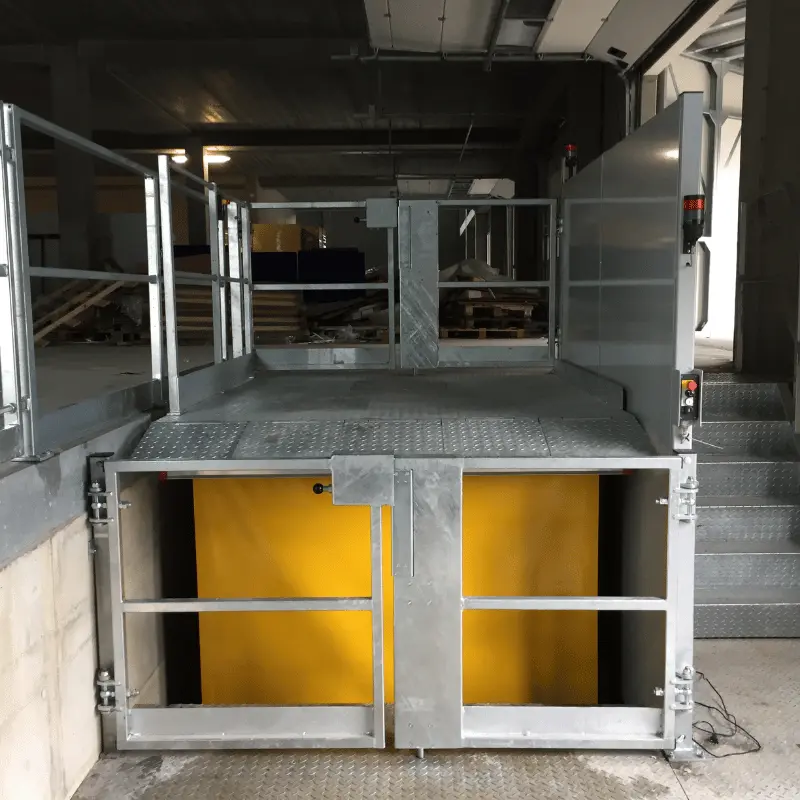 Dock Lift in the warehouse front-facing beside stairs.