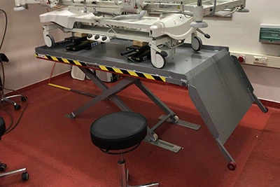 Metal low profile lift table on a red carpet
