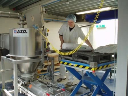 Worker operating scissor lifts, moving heavy goods.